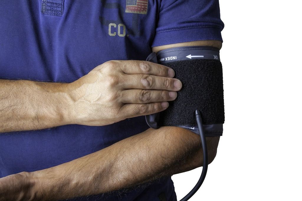 A nurse checks a patient's blood pressure