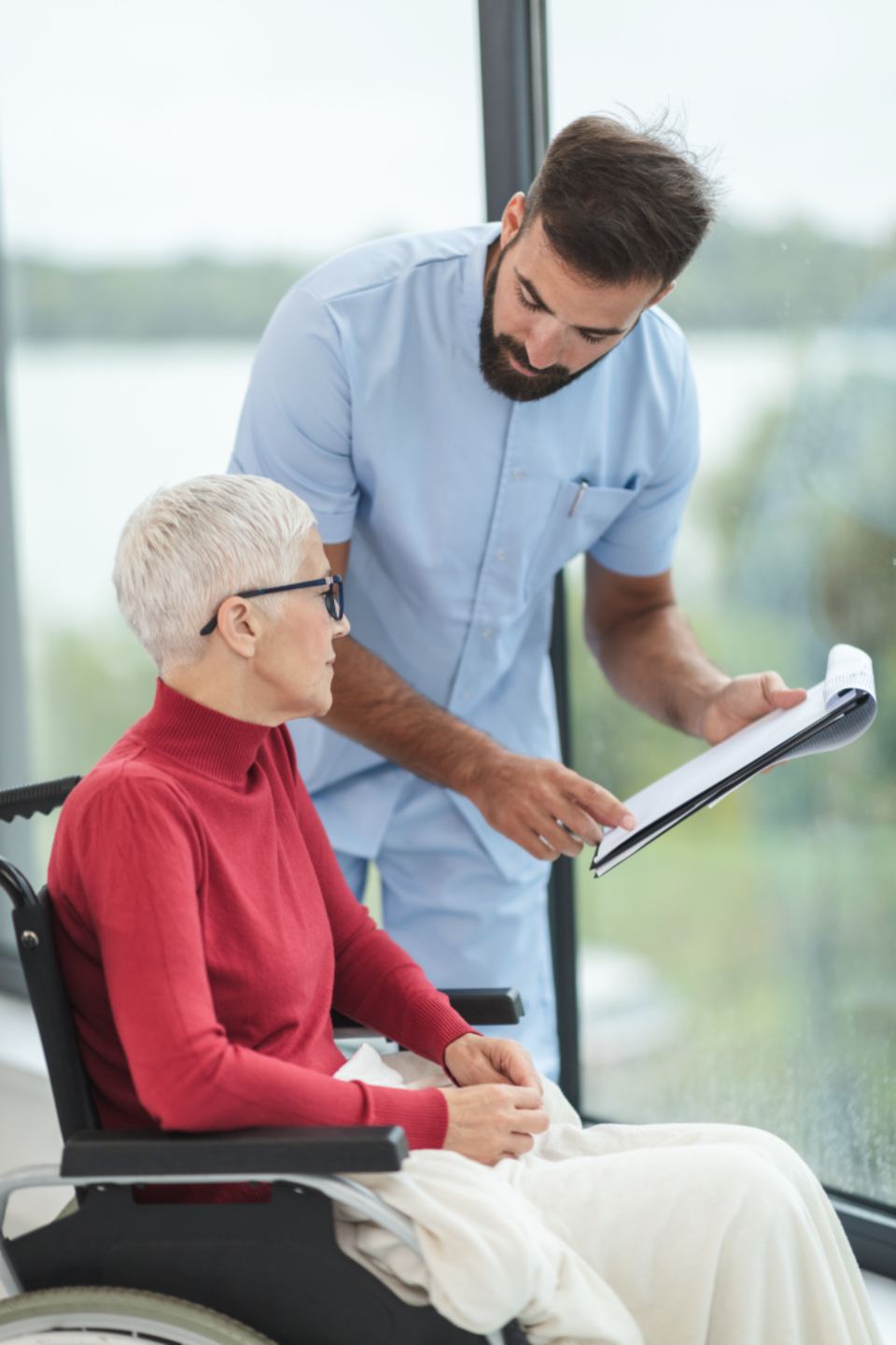 A caregiver reviews a care plan with a senior woman
