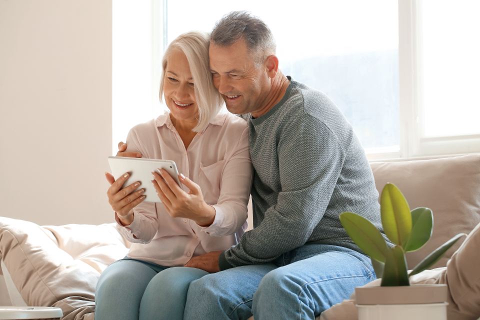 An older couple relaxing together on the sofa at home