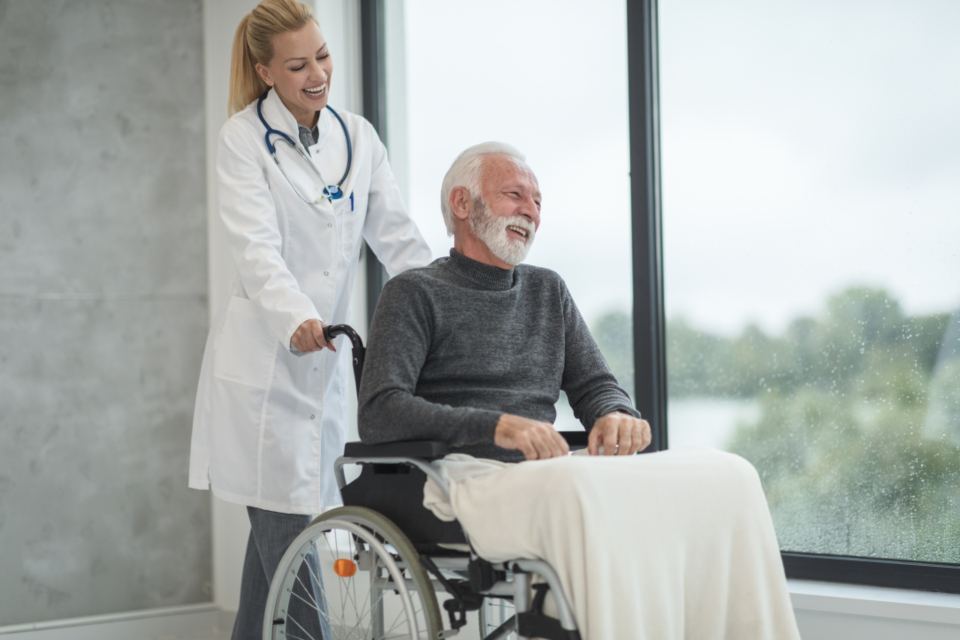 A doctor sharing a laugh with an older patient