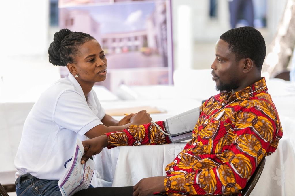 A nurse talks with a patient during a home visit